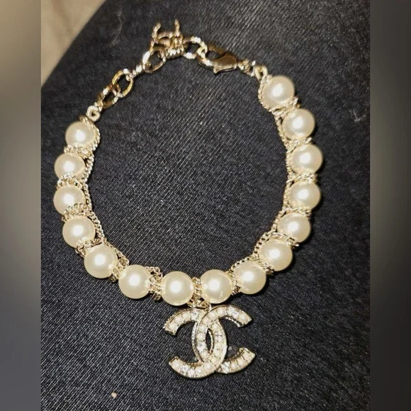 Gold-Tone Pearl Bracelet with Crystallized Logo Pendant - Picture 4 of 7